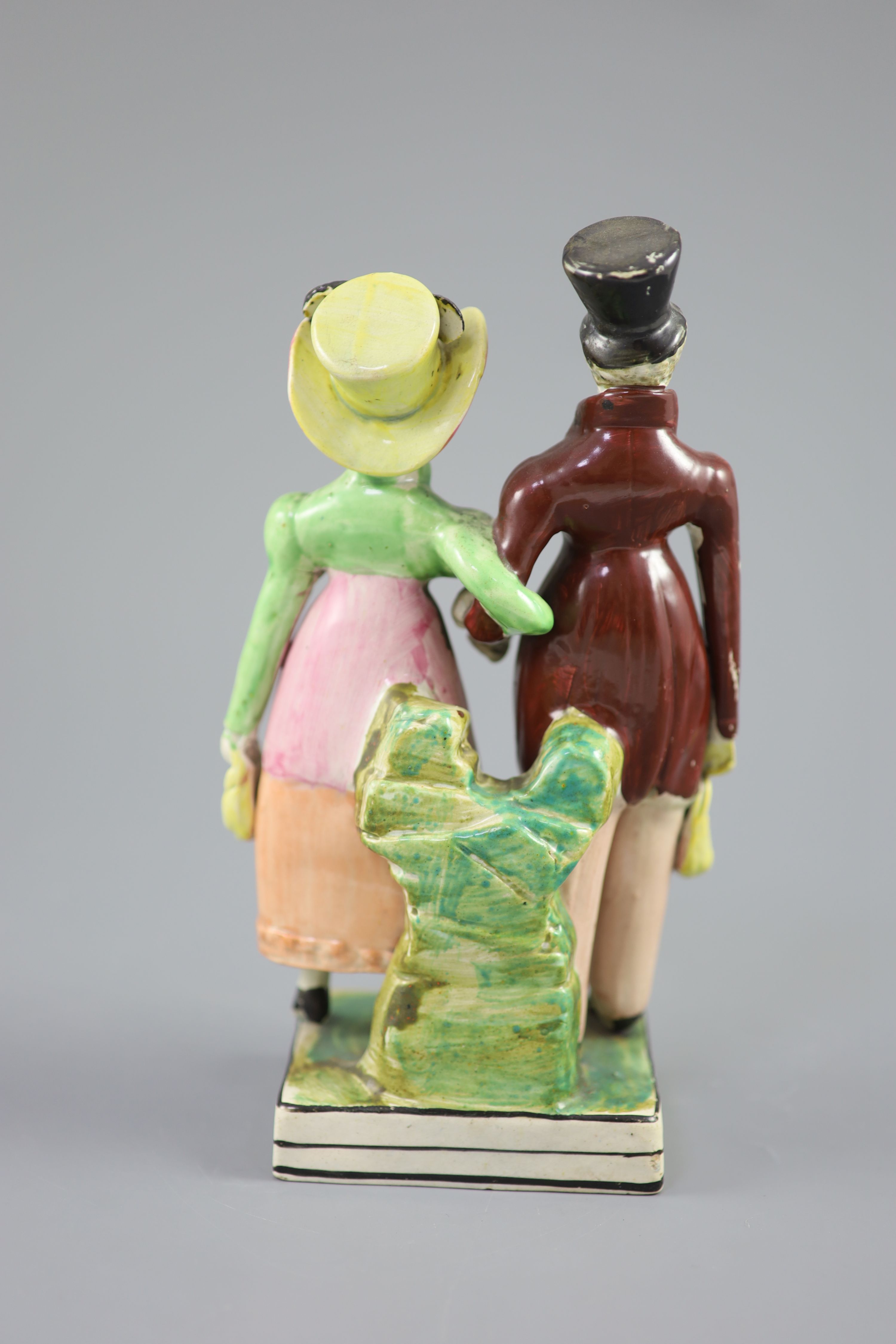 A Staffordshire pearlware group of a Dandy and Dandizette, c.1820, 21cm high